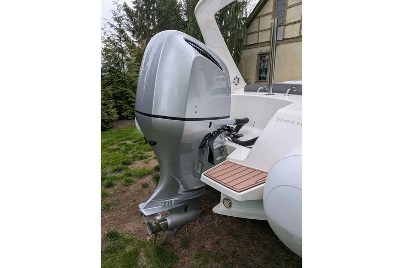 Slide: The Image of Silver outboard motor on a 2016 Brig E780 boat, parked on grass. - 17