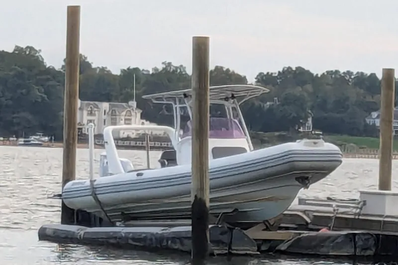 Slide: The Image of 2016 Brig E780 boat docked on a calm waterfront with scenic background. - 21