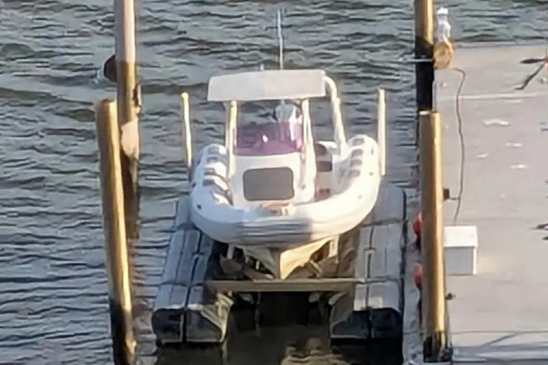 Slide: The Image of 2016 Brig E780 boat docked on a lift at a marina. - 3