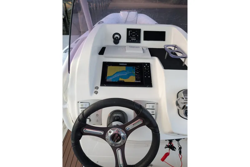 Slide: The Image of Steering console of 2016 Brig E780 boat with navigation display and controls. - 8
