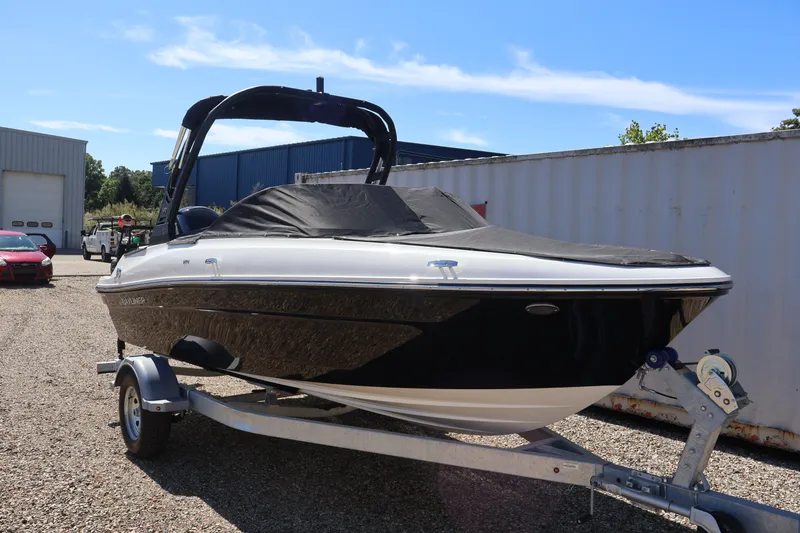 Slide: The Image of 2026 Bayliner VR4 Bowrider OB on trailer, covered, outdoors in a storage area. - 37