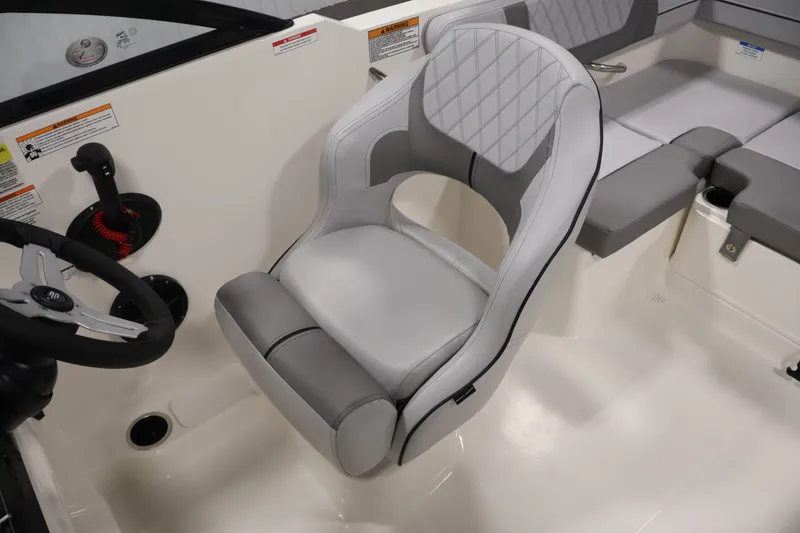 Slide: The Image of 2026 Bayliner VR4 Bowrider OB interior with sleek, modern seating and steering wheel. - 23