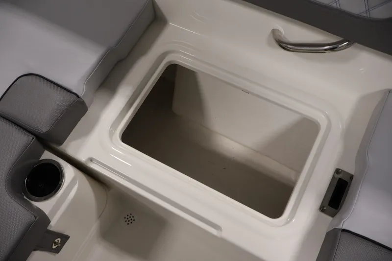 Slide: The Image of 2026 Bayliner VR4 Bowrider OB interior storage compartment with cushioned seating and cup holder. - 31