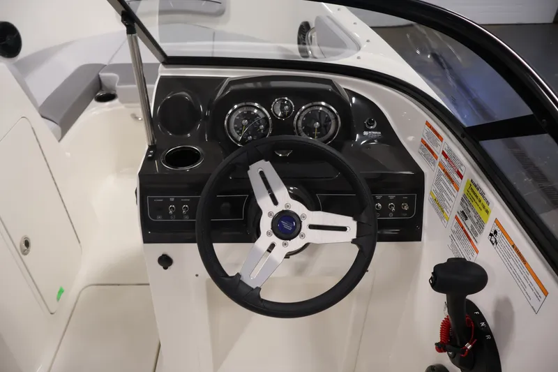 Slide: The Image of 2026 Bayliner VR4 Bowrider OB dashboard with steering wheel and control panel. - 17