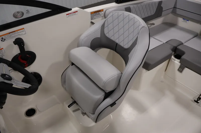 Slide: The Image of 2026 Bayliner VR4 Bowrider OB interior with gray seating and steering wheel. - 24