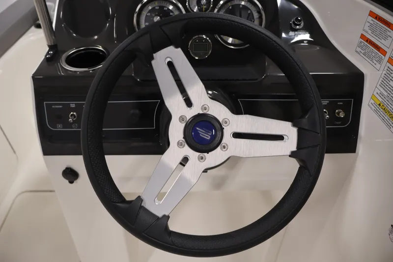 Slide: The Image of Steering wheel of 2026 Bayliner VR4 Bowrider OB boat, featuring modern dashboard controls. - 18