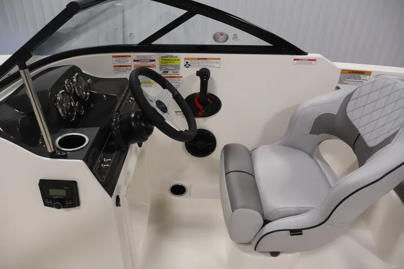 Slide: The Image of 2026 Bayliner VR4 Bowrider OB cockpit with steering wheel and cushioned seat. - 16