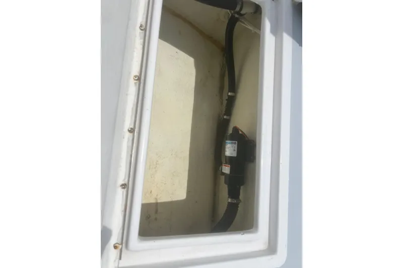Slide: The Image of 1973 Bertram 31 Flybridge Cruiser compartment with installed pump and hoses. - 17