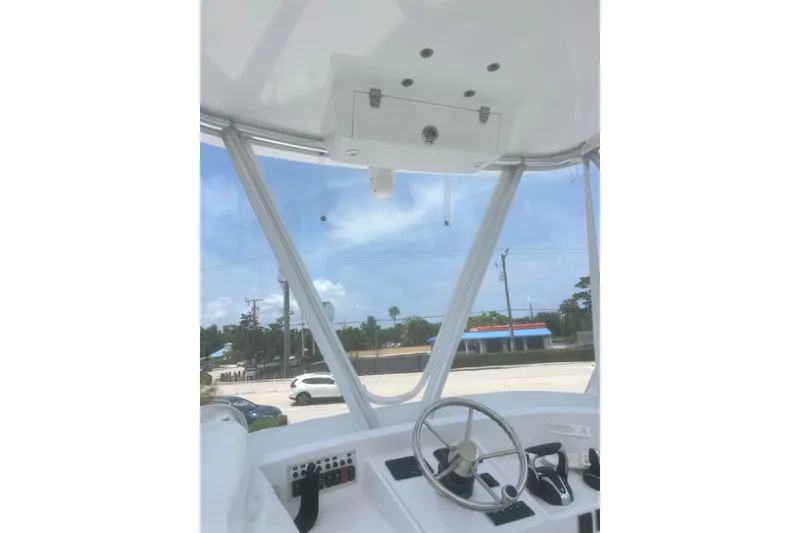 Slide: The Image of Interior view of a 1973 Bertram 31 Flybridge Cruiser helm with steering wheel and controls. - 22