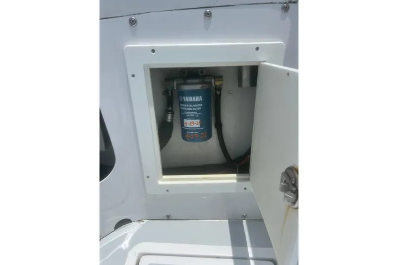 Slide: The Image of 1973 Bertram 31 Flybridge Cruiser fuel filter compartment with Yamaha filter. - 15
