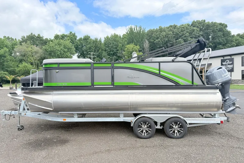 The Image of 2026 Qwest E-Class RLS 18 pontoon boat on trailer, green and gray design. - 0