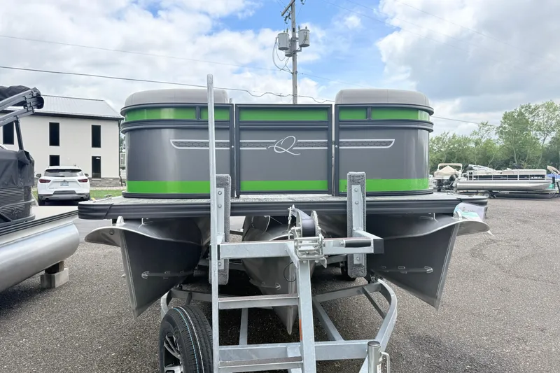 Slide: The Image of 2026 Qwest E-Class RLS 18 pontoon boat on trailer, parked outdoors. - 1