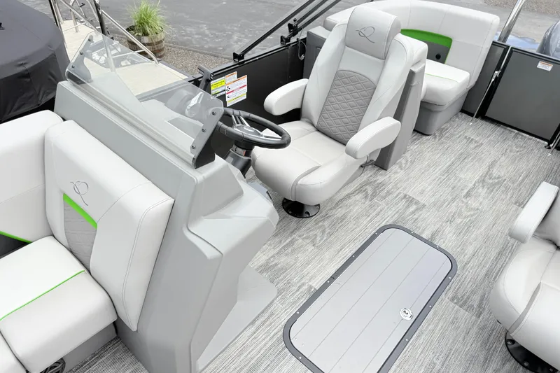 Slide: The Image of Interior of 2026 Qwest E-Class RLS 18 pontoon boat with modern seating and steering console. - 15
