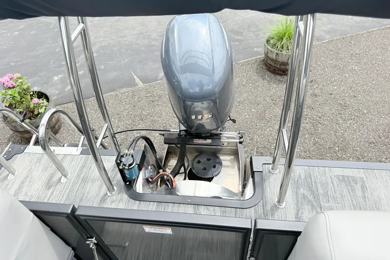 Slide: The Image of 2026 Qwest E-Class RLS 18 boat with Yamaha outboard motor, docked on textured surface. - 6