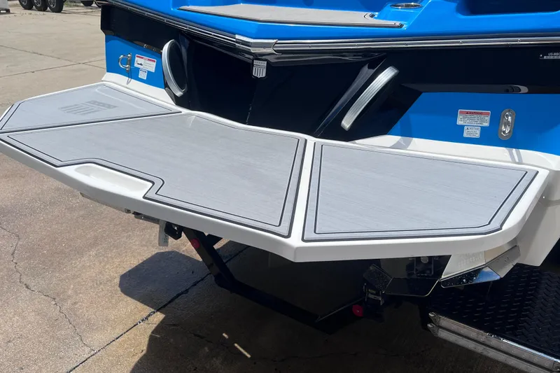 Slide: The Image of 2021 MasterCraft XT23 boat with sleek swim platform and blue exterior. - 9