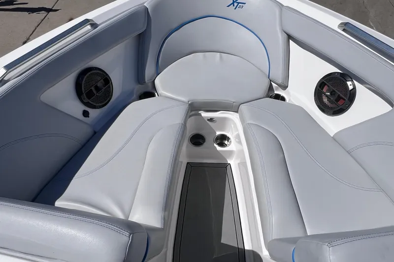 Slide: The Image of Interior of 2021 MasterCraft XT23 boat with gray seating and built-in speakers. - 18