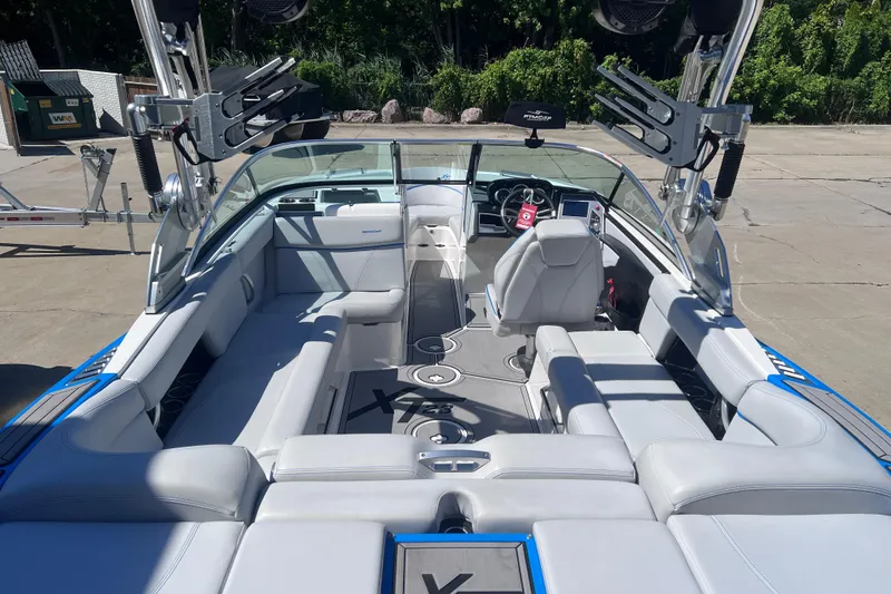 Slide: The Image of 2021 MasterCraft XT23 boat interior with sleek seating and modern dashboard. - 10