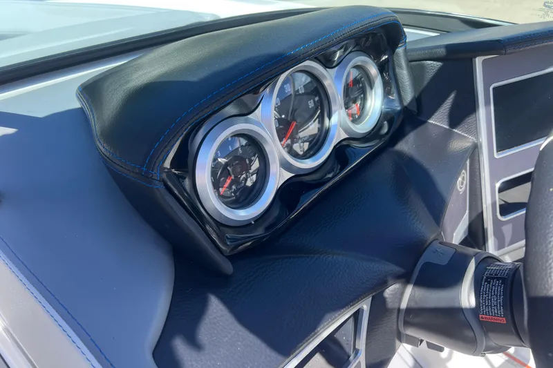 Slide: The Image of Dashboard of a 2021 MasterCraft XT23 boat with gauges and steering wheel. - 15
