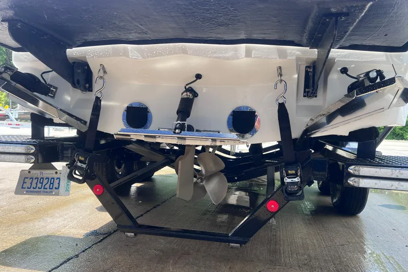 Slide: The Image of Rear view of a 2021 MasterCraft XT23 boat on a trailer, showing propeller and license plate. - 6