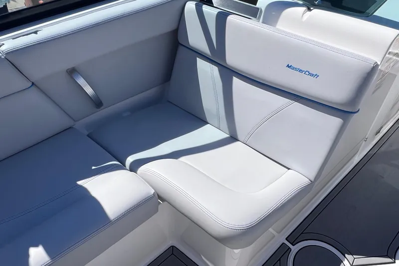 Slide: The Image of 2021 MasterCraft XT23 boat interior with white cushioned seating. - 17
