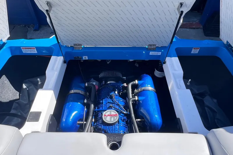 Slide: The Image of 2021 MasterCraft XT23 boat engine compartment with Ilmor engine, blue and white interior. - 20