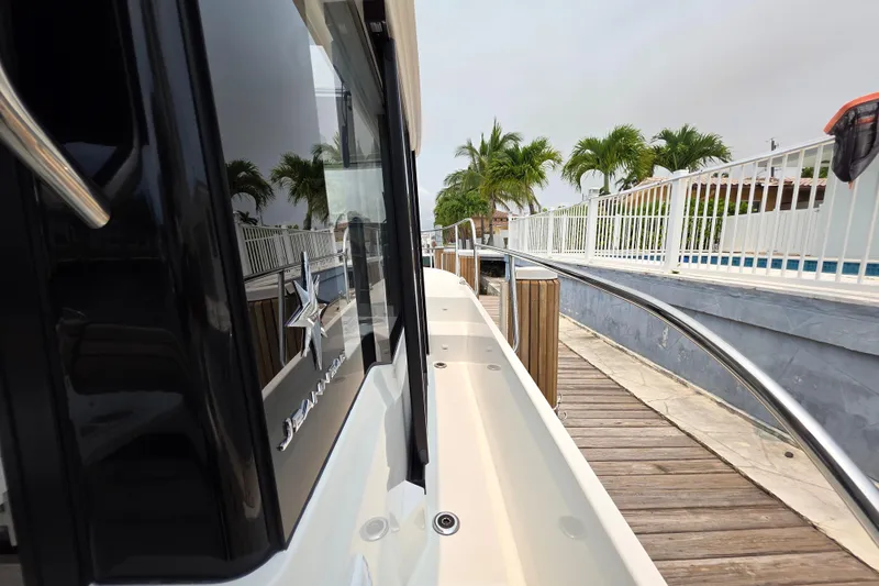 Slide: The Image of 2025 Jeanneau NC 895 Series 2 docked, showcasing sleek design and modern features. - 17
