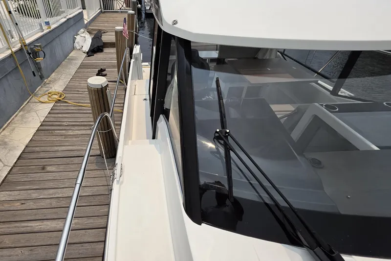 Slide: The Image of 2025 Jeanneau NC 895 Series 2 docked, showcasing sleek design and modern features. - 21
