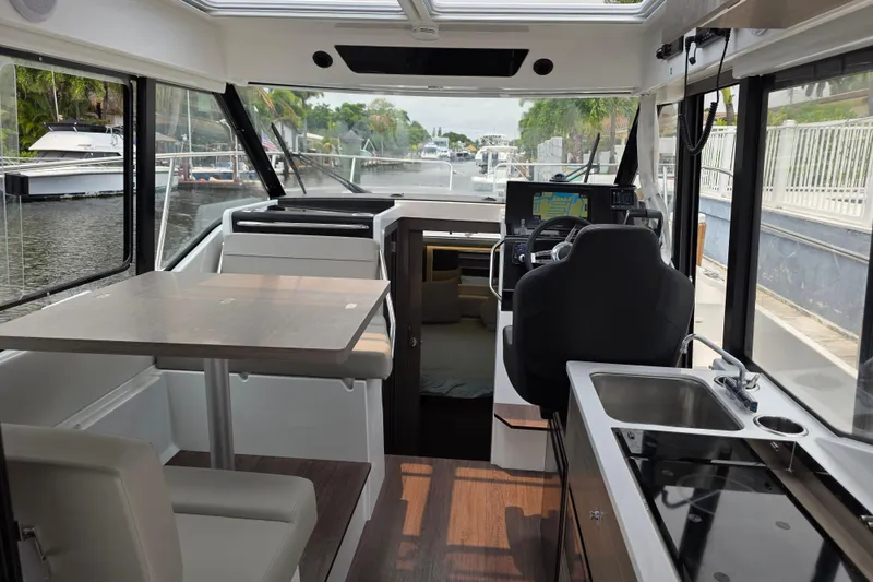 Slide: The Image of Interior of 2025 Jeanneau NC 895 Series 2 boat with modern kitchen and seating area. - 24