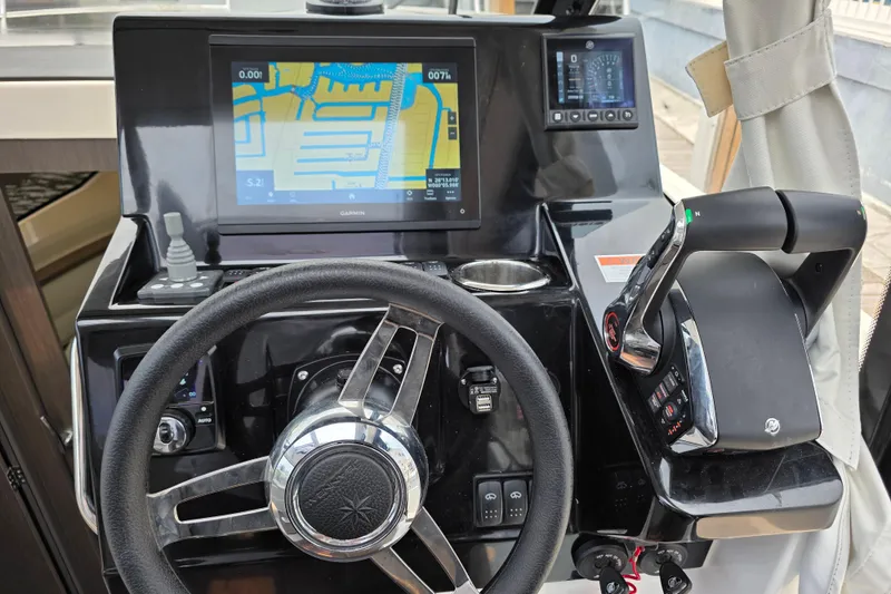 Slide: The Image of Helm of 2025 Jeanneau NC 895 Series 2 with navigation display and controls. - 25