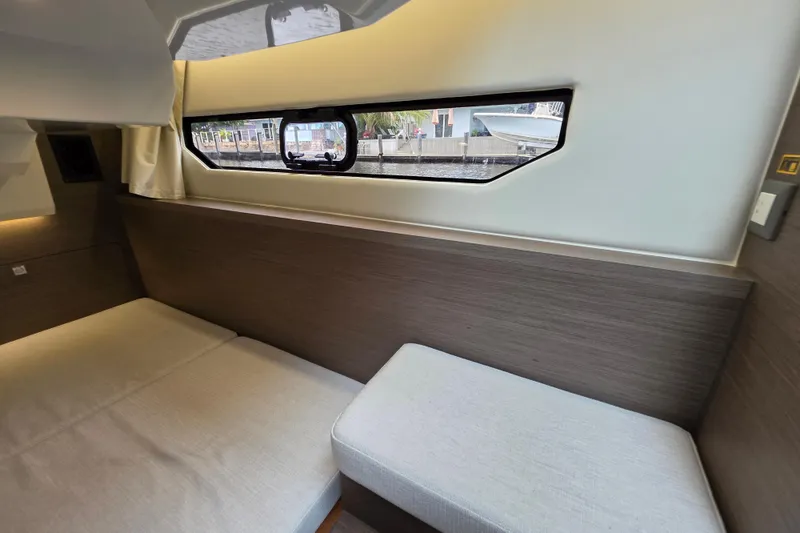 Slide: The Image of Interior cabin of 2025 Jeanneau NC 895 Series 2, featuring a cozy bed and window view. - 31