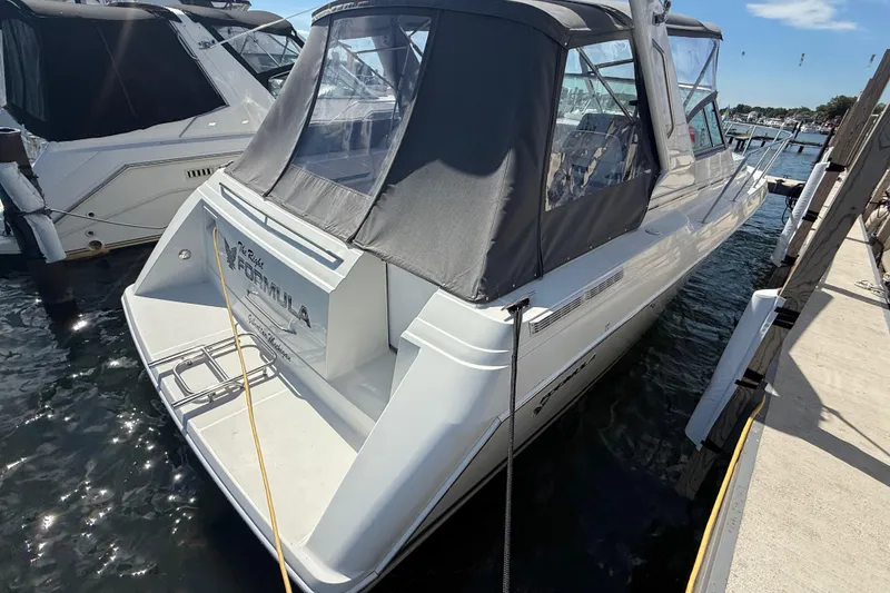 Slide: The Image of 1999 Formula 34 Performance Cruiser docked at marina, rear view with canopy. - 12