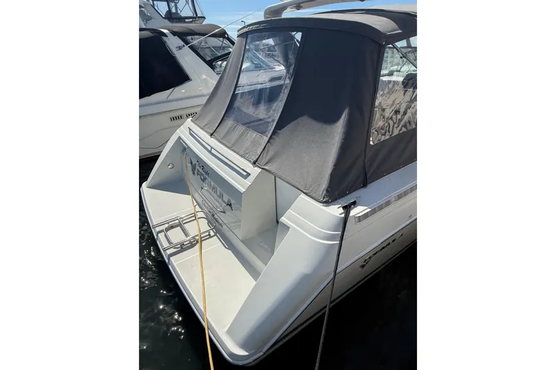Slide: The Image of 1999 Formula 34 Performance Cruiser docked, featuring a sleek design and covered cockpit. - 13