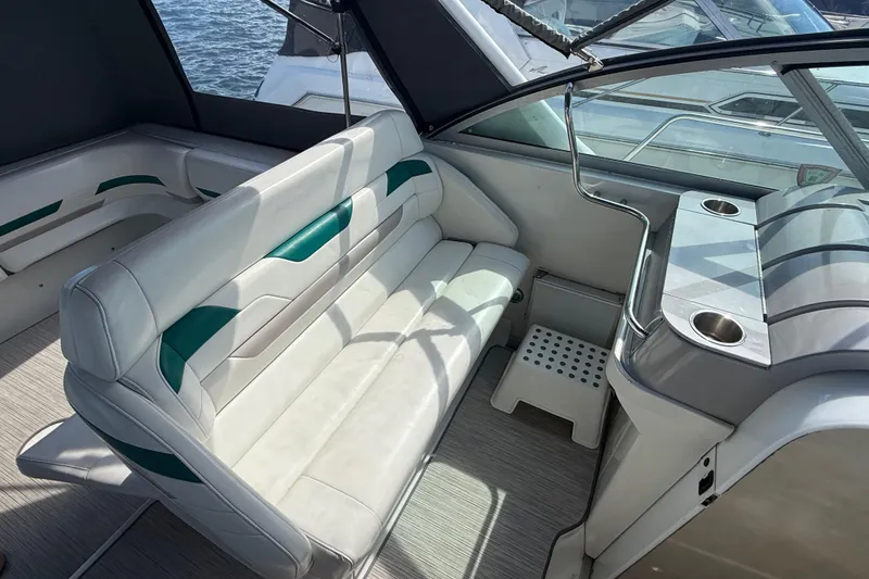 Slide: The Image of Interior of a 1999 Formula 34 Performance Cruiser with white seating and cup holders. - 15