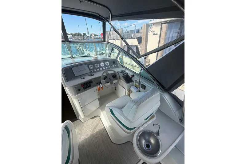 Slide: The Image of 1999 Formula 34 Performance Cruiser helm with Garmin navigation, steering wheel, and sink. - 17