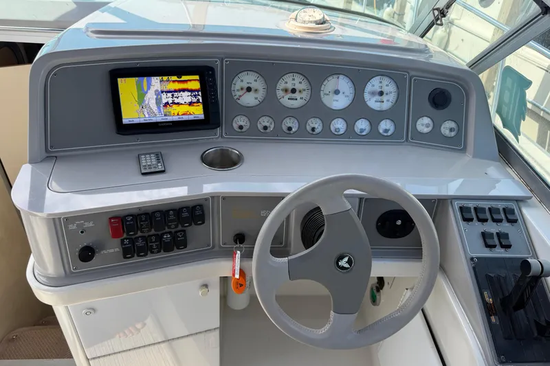 Slide: The Image of 1999 Formula 34 Performance Cruiser dashboard with steering wheel and navigation instruments. - 19