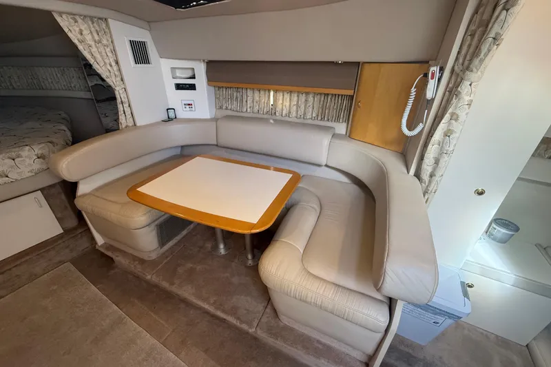 Slide: The Image of Interior of a 1999 Formula 34 Performance Cruiser with beige seating and a wooden table. - 31