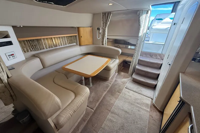 Slide: The Image of Interior of a 1999 Formula 34 Performance Cruiser with plush seating and dining area. - 35