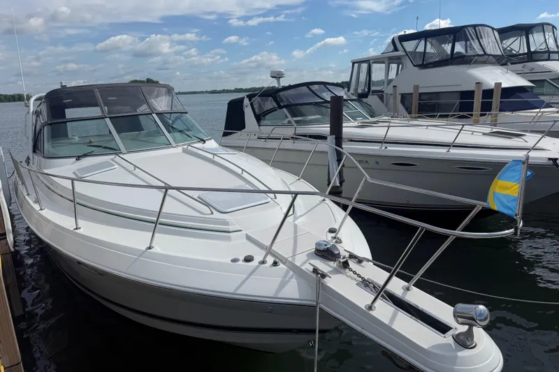 Slide: The Image of 1999 Formula 34 Performance Cruiser docked, featuring sleek design and spacious deck under a clear sky. - 4