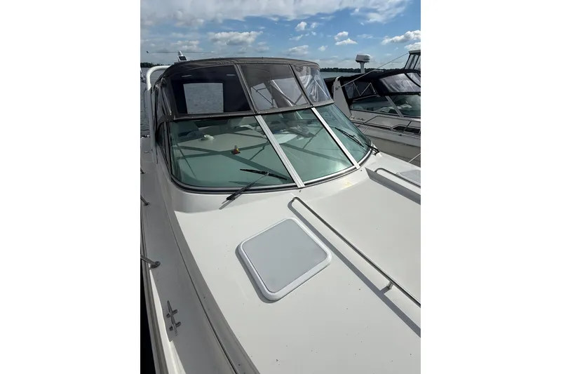 Slide: The Image of 1999 Formula 34 Performance Cruiser boat docked under a partly cloudy sky. - 6