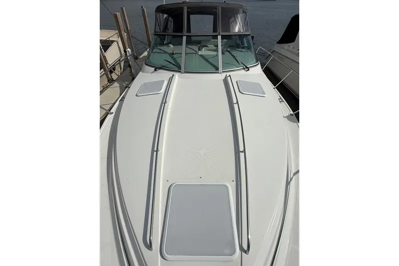 Slide: The Image of 1999 Formula 34 Performance Cruiser boat docked, showcasing sleek white deck design. - 7