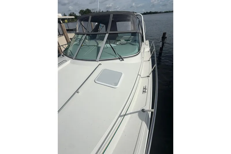 Slide: The Image of 1999 Formula 34 Performance Cruiser docked on a calm lake under a cloudy sky. - 8