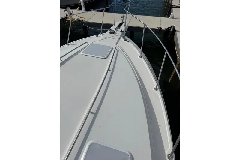 Slide: The Image of 1999 Formula 34 Performance Cruiser docked, showcasing sleek deck design and railing. - 9