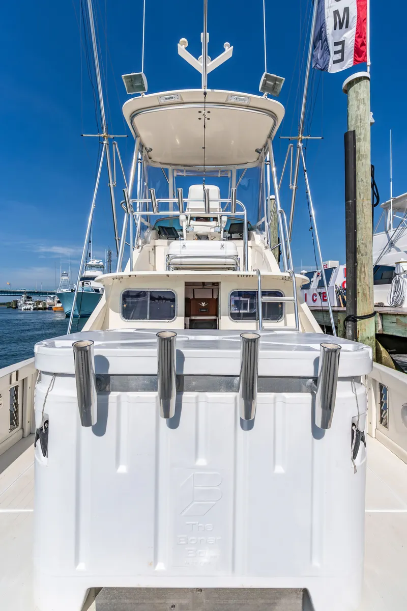 Slide: The Image of 1979 Bertram Flybridge Cruiser docked at a marina. - 10