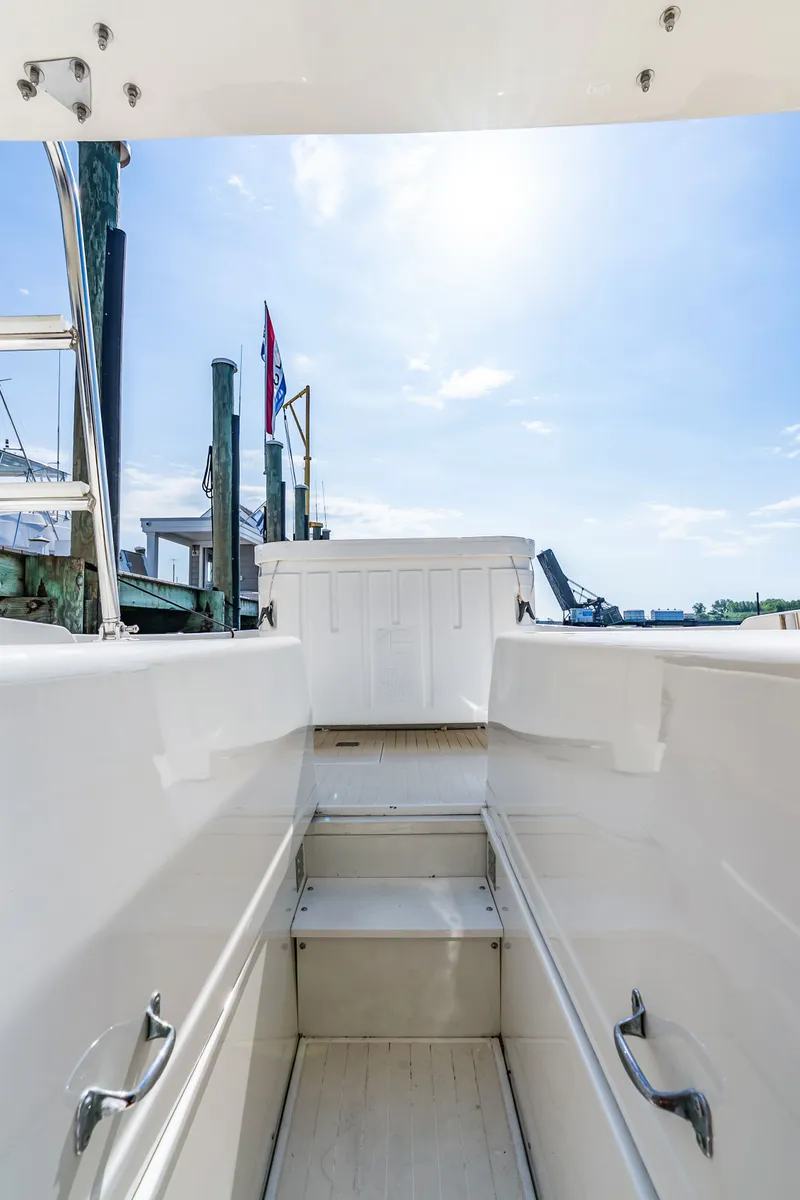 Slide: The Image of View of the steps on a 1979 Bertram Flybridge Cruiser leading to a sunny deck. - 16