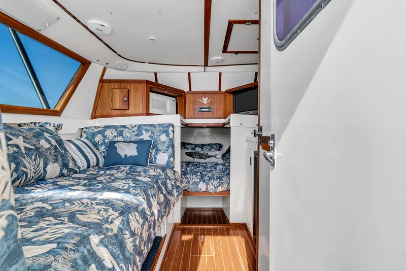 Slide: The Image of Interior of a 1979 Bertram Flybridge Cruiser with blue upholstery and wood accents. - 20