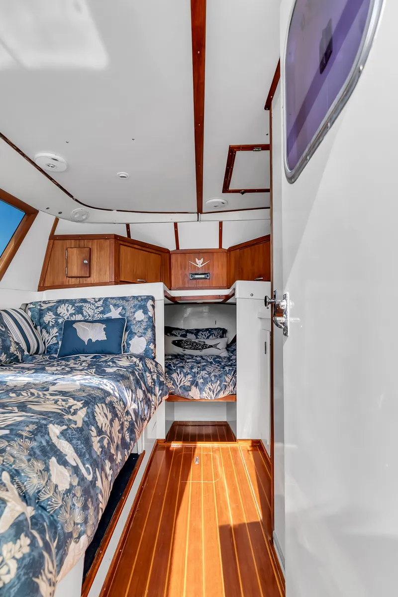 Slide: The Image of Interior of the 1979 Bertram Flybridge Cruiser with wood flooring and blue upholstery. - 21