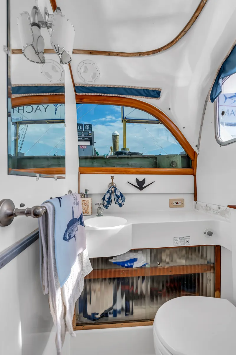 Slide: The Image of Interior view of a boat bathroom with sink, mirror, and window overlooking the harbor. - 25