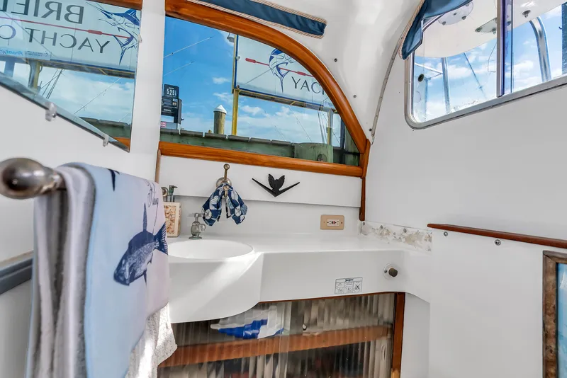 Slide: The Image of Interior of a 1979 Bertram Flybridge Cruiser with a sink and mirror. - 29