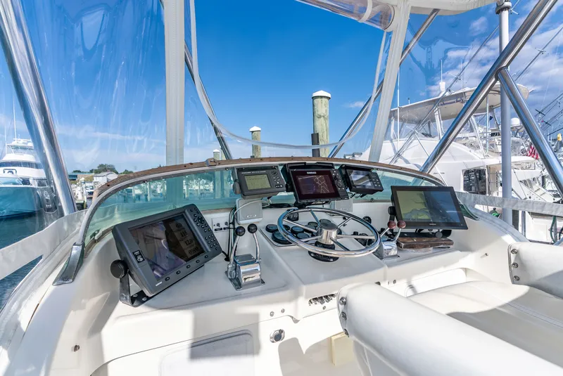 Slide: The Image of The cockpit of a 1979 Bertram Flybridge Cruiser with modern navigation electronics. - 40