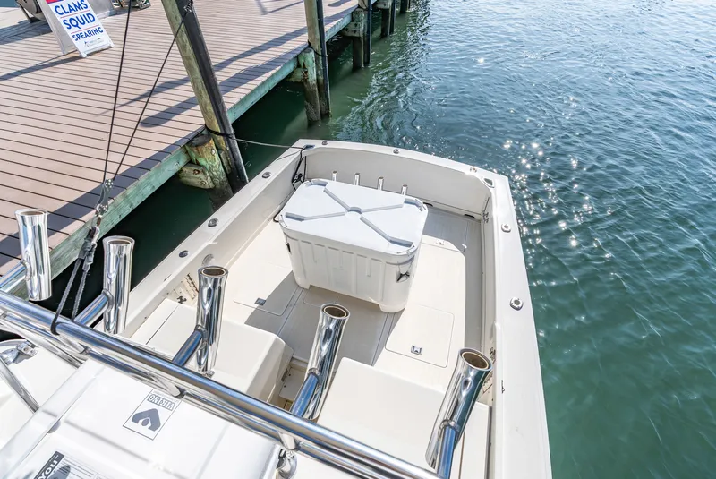 Slide: The Image of 1979 Bertram Flybridge Cruiser at dock with cooler and fishing rod holders. - 41